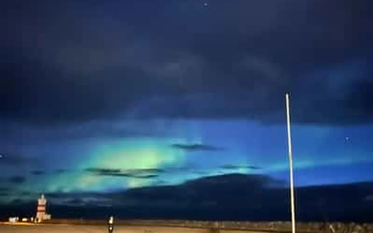 A faint green aurora low over the Icelandic coast