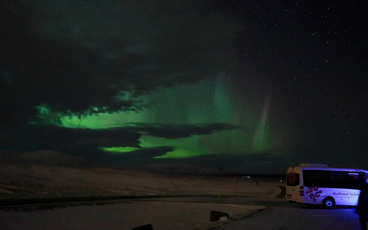 A bright aurora over a viewpoint outside Reykjavik