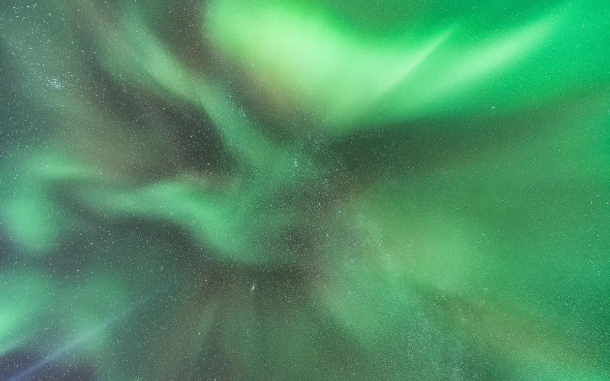 A bright green aurora filling the sky over Iceland
