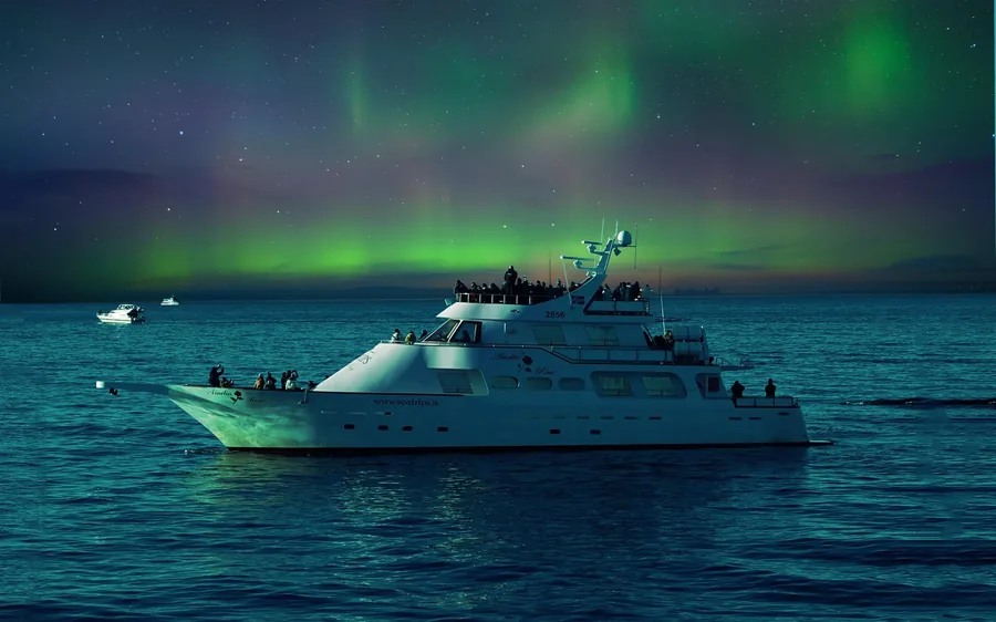 A boat leaving Reykjavik harbour at night